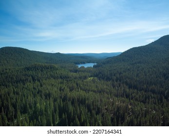 Cloudy Landscape. Twilight. Hilly Area With Green Grass, Small Lake And Sky With White Clouds. Beauty And Grandeur Of Wild Nature. Desert Place. Ecology, Clean Air, Relaxation, Solitude.