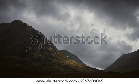 Cloudy moody sky over the mountains of Glencoe in the Scottish HIghlands