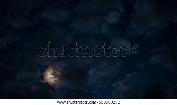 Cloudy and moon in the night\
sky.