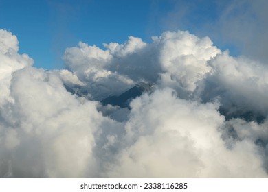 Cloudy mountains.
Mountains in clouds at sunrise in summer. Aerial view of mountain peak with green trees in fog. Top view of mountain valley in low clouds from drone. Rize Huser plateau, Türkiye - Powered by Shutterstock