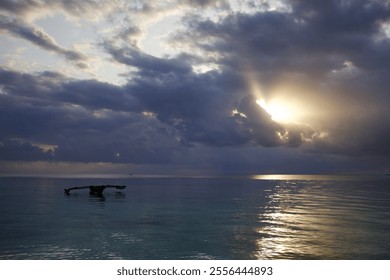 Cloudy sky above the Indian Ocean with a fishing boat and calm waters - Powered by Shutterstock