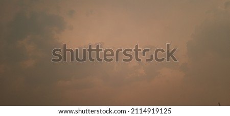 cloudy sky after a forest fire in acrid yellow-gray smoke