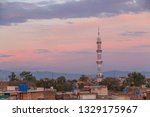  Cloudy sky is preparing to rain soon,  mosque in a Village view, Mosque  Minaret against blue sky in Rawalpindi, Pakistan.  