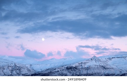 Cloudy Sky with snowy Mountain range, red light and full moon - Powered by Shutterstock