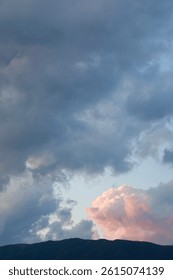 Cloudy sky and sunset clouds, mountain silhouette