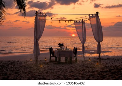 cloudy sky at sunset with table dinner romantic,Luxury dinner on beach    - Shutterstock ID 1336106432