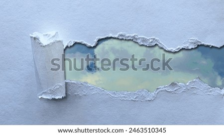 Cloudy sky and torn blue paper together. Space to write text, copy space. Paper for writing slogans about nature and environmental protection.