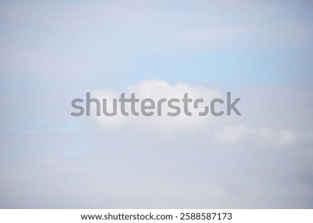 A cloudy sky with a white cloud in the middle. The sky is mostly blue with a few white clouds scattered throughout