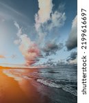 Cloudy stormy dramatic sky background, Dark ominous blue and red storm clouds. Rainy sunset sky over the Baltic sea.