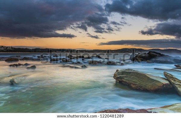 Cloudy Sunrise Seascape Rock Platform Haven Stock Photo - 