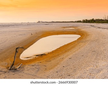 Cloudy Sunset in Small Tide Pool on South Beach, Lovers Key State Park, Florida, USA