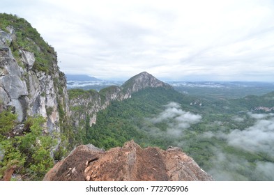 Cloudy view on top of a mount with clouds at foreground and background