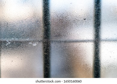 Cloudy window with bars in prison