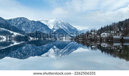 Cloudy winter Alpine  lake Grundlsee panorama (Austria) with fantastic pattern-reflection on the water surface.