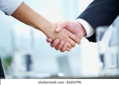 Clouse-up of businessman and  businesswoman shaking hands