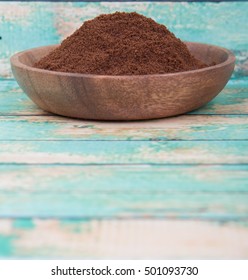 Clove Powder In Wooden Bowl Over Wooden Background