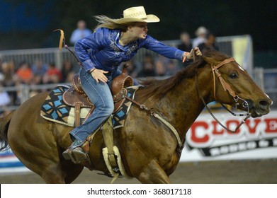 CLOVERDALE, CANADA - MAY 19, 2012: A cowgirl competes in Ladies Barrel Race category at the annual Cloverdale Rodeo on May 19, 2012 in Cloverdale, BC, Canada.