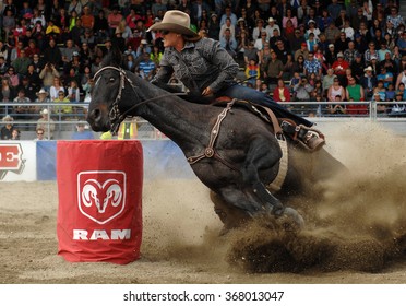 CLOVERDALE, CANADA - MAY 21, 2012: A cowgirl competes in Ladies Barrel Race category at the annual Cloverdale Rodeo on May 21, 2012 in Cloverdale, BC, Canada.