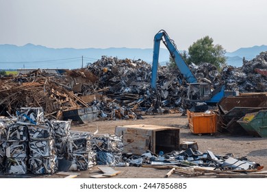 Clow crane picking up scrap metal at recycling center for metal, aluminum, brass, copper, stainless steel in junk yard. Recycling industry. Environment, Earth day and zero waste concept - Powered by Shutterstock