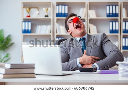 Clown businessman having fun in the office