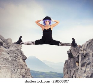 Clown Dancer Makes Split Between Two Mountains