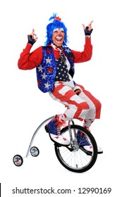 Clown Riding A Unicycle With Training Wheels