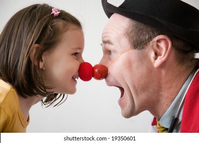 Clown-doctor : Red Nose Contact Of Clown With Kid. Profiles Of Man And Girl.