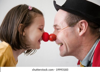 Clown-doctor : Red Nose Contact Of Clown With Kid. Profiles Of Man And Girl.