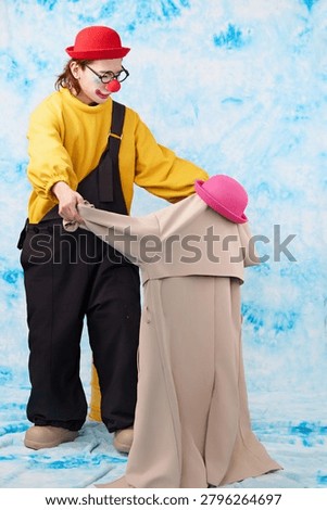 Clown-dressed comedians performing prop misdirection acts