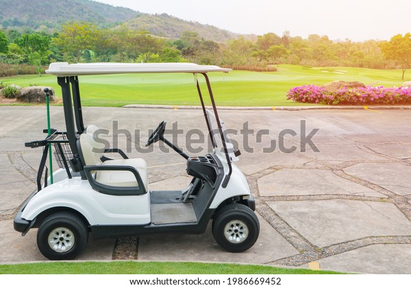 Club Car or Golf Cart in a golf course with green\
lawns on sunny day.