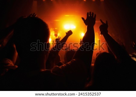 Club, concert and audience with hands or lights for music, party and rave festival with silhouette and dancing. Disco, psychedelic event or performance with entertainment, crowd and rear view gesture