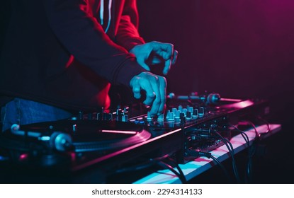 Club DJ mixing music set. Professional disc jokey playing hip hop on a party - Shutterstock ID 2294314133