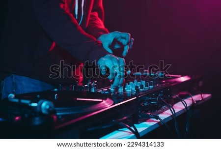 Club DJ mixing music set. Professional disc jokey playing hip hop on a party