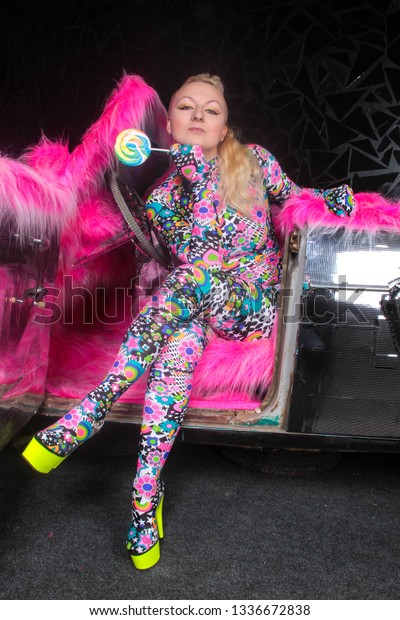 club
party blonde girl in acid anime style spandex catsuit with mirror
car with pink fur ready for crazy clubbing
life