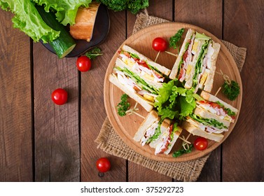 Club Sandwich With Cheese, Cucumber, Tomato, Ham And Eggs. Top View