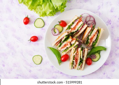 Club Sandwich With Chicken Breast, Bacon, Tomato, Cucumber And Herbs. Top View