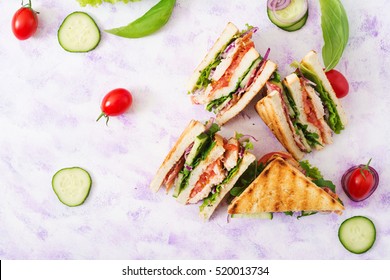 Club Sandwich With Chicken Breast, Bacon, Tomato, Cucumber And Herbs. Top View