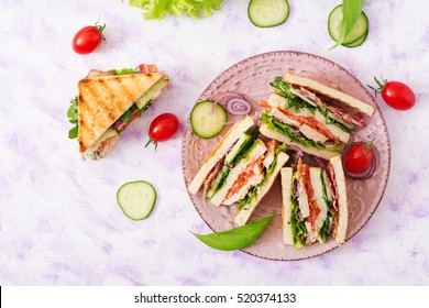 Club Sandwich With Chicken Breast, Bacon, Tomato, Cucumber And Herbs. Top View/