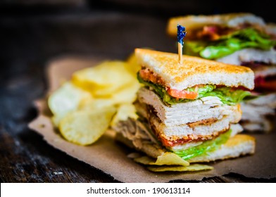 Club sandwich on rustic wooden background