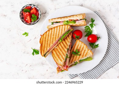 Club sandwich panini with ham, tomato, cheese and lettuce. Top view