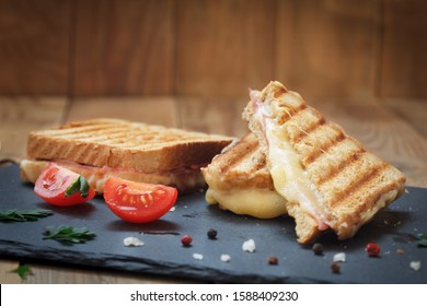Club sandwiches for quick breakfast. Grilled or toasted sandwiches with ham salami, tomato and melted cheese.