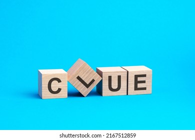 Clue - Word Is Written On Wooden Cubes Close-up. Bright Blue Background, Financial Business Concept.