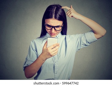 Clueless Dumb Looking Girl Having Troubles With Her Smartphone. Complicated Technology Concept 