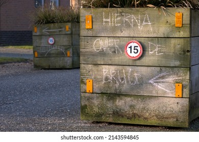 Clues On A Wooden Planter On A Holiday Park For A Scavenger Hunt For Children With The Text 