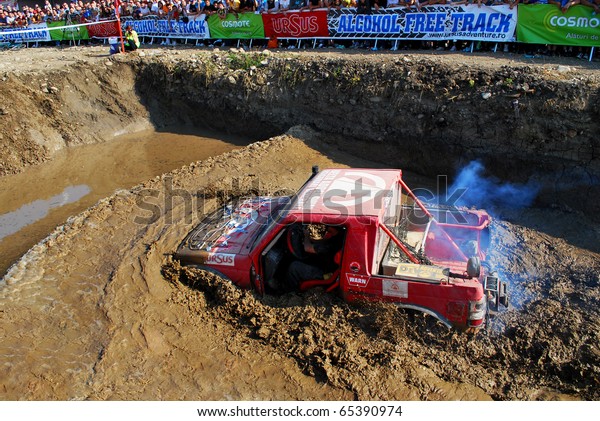 CLUJ
NAPOCA, ROMANIA - SEPT. 26 : An Off-road car drives through water
in a specially designed hole on Sept. 26, 2009 at 