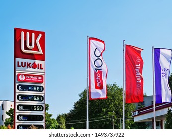 Cluj-Napoca - August 30, 2019: Lukoil logo price display and flags in front of a gas station. Lukoil is a major Russian oil company headquartered in Moscow. Translation: Promotion. Ask at the station