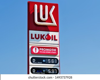 Cluj-Napoca - August 30, 2019: Lukoil logo with price display in front of a gas station. Lukoil is a major Russian oil company headquartered in Moscow. Translation: Promotion. Ask now at the station.