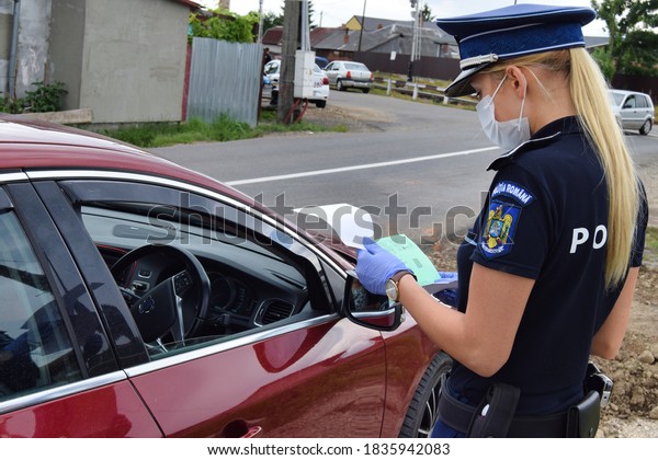 Cluj-Napoca,\
Cluj/Romania-07.09.2020-Police officers carry out traffic checks\
regarding the observance of the road norms as well as those of\
COVID 19. All agents wear protective\
masks