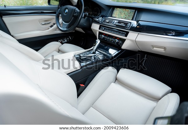 Cluj-Napoca, Cluj-Romania-07.09.2021-Wood grain and\
white leather come together to make up the beautiful interior of\
this BMW sedan. Every detail is crafted to create the perfect\
driving experience.\

