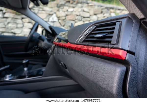 Cluj-Napoca, Cluj,Romania-07.28.2019-Sporty interior\
with red accents of a BMW 3 Series,M Performance,sedan,very\
maintained,year of manufacture 2012,manual,head up display and\
business navigation\
unit